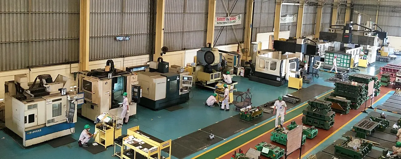 A machinist at work on a CNC production floor