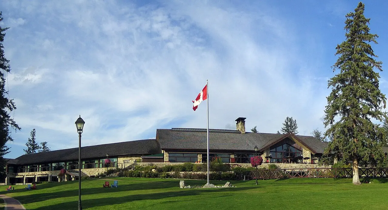 The Fairmont Jasper Park Lodge under a Canadian flag