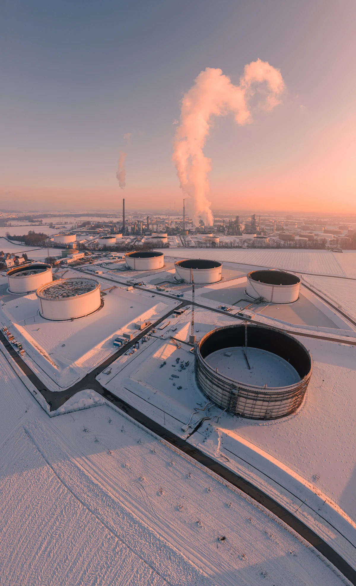 Industrial tank yard at sunrise